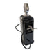 A side-angle product photograph of a Buc-ee’s gas pump dual beverage dispenser against a white background. The image shows the dispenser from a three-quarter perspective, highlighting its glossy black finish and chrome hardware. A silver-coiled hose extends from the bottom and wraps around to the side, where a chrome nozzle is docked in a metal bracket. The circular chrome topper at the peak displays a faint, engraved Buc-ee’s beaver logo. 