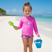 Toddler in a Buc-ee's Girl's Tropical Floral Swim Set at the beach