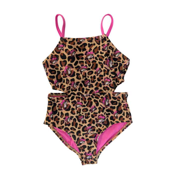 A girls' one-piece swimsuit featuring a trendy cutout design on both sides of the waist. The suit is covered in a brown and black leopard print pattern with small pink circular icons of the Buc-ee's beaver mascot scattered throughout. It features bright pink spaghetti-style shoulder straps and bright ink lining, swimsuit displayed in a clean white background.
