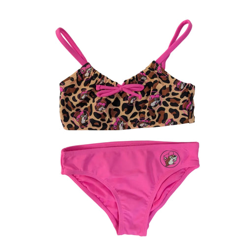A girls' two-piece bikini set. The top features a leopard print pattern with pink Buc-ee's beaver icons and bright pink shoulder straps and pink bow in the middle of the chest. The matching bottoms feature a solid bright pink front with a small circular Buc-ee's mascot logo on the left hip, displayed on a clean white background.