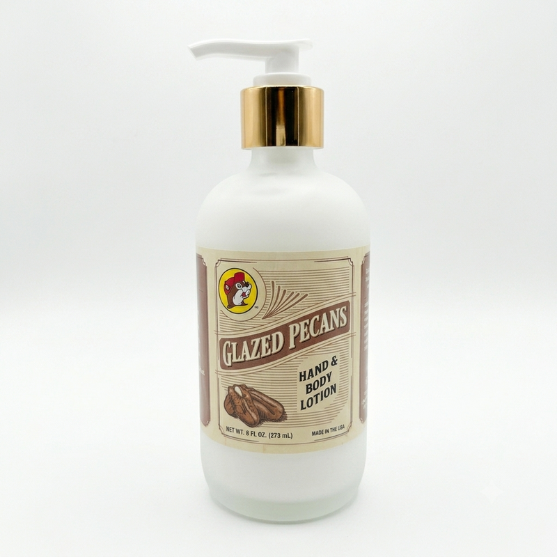 A square product shot of an 8 oz frosted glass pump bottle of Buc-ee's Glazed Pecans Hand & Body Lotion, featuring a gold neck collar and a white pump nozzle pointing to the left, isolated against a seamless, solid white background.