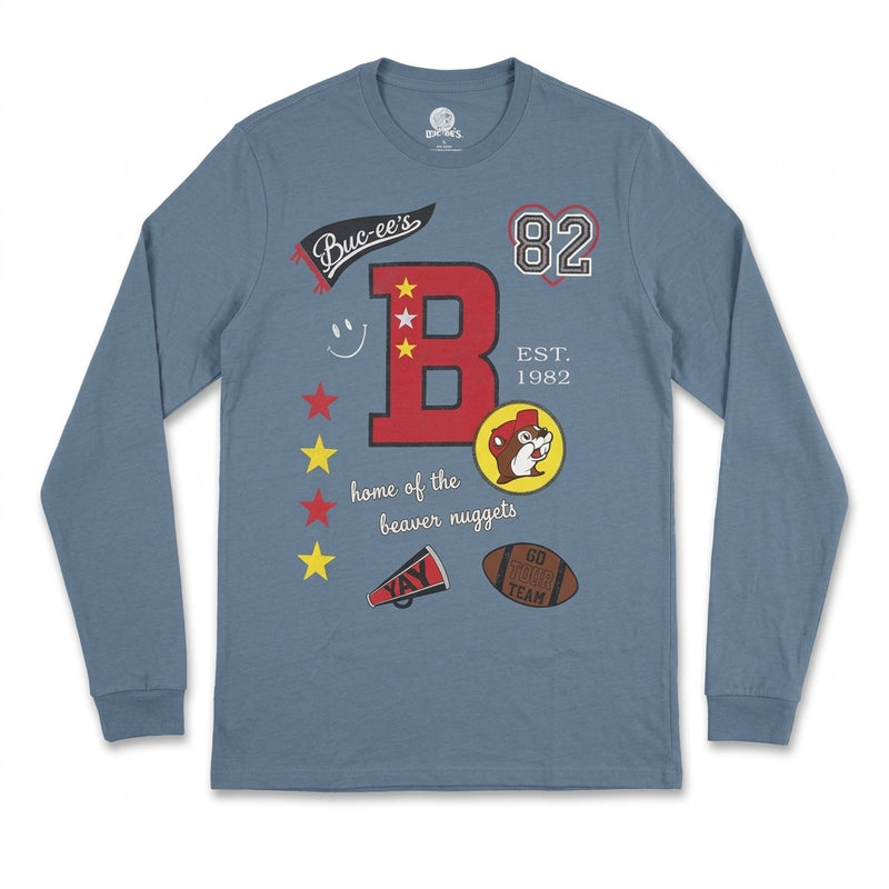 Slate blue long-sleeve t-shirt laid flat featuring a front collage graphic with a large red varsity letter B, Buc-ee's logo, football, megaphone, and "EST. 1982".