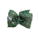 A Buc-ee's St. Patrick's Day green hair bow with a vibrant green base covered in a pattern of Buc-ee the beaver wearing a leprechaun hat, lucky shamrocks, and gold accents, displayed on a clean white background.
