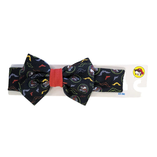 Buc-ee's Halloween soft fabric headband with an oversized bow featuring vampire Buc-ee and neon bats with a red-orange center knot on a packaging hanger.
