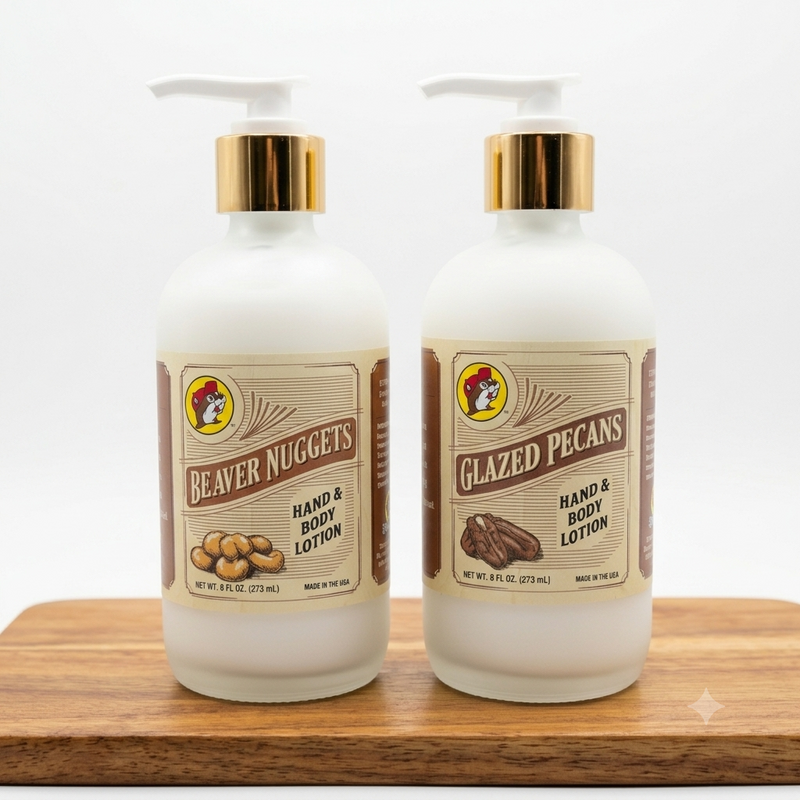 A photo of two frosted glass bottles of Buc-ee's Hand & Body Lotion on a light wooden cutting board against a white background. One bottle is labeled "Beaver Nuggets" and the other "Glazed Pecans." Both have white pumps and gold collars.