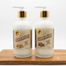 A photo of two frosted glass bottles of Buc-ee's Hand & Body Lotion on a light wooden cutting board against a white background. One bottle is labeled "Beaver Nuggets" and the other "Glazed Pecans." Both have white pumps and gold collars.