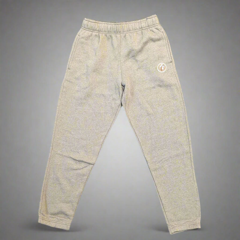 Flat lay of Buc-ee’s heather brown jogger pants with elastic waistband and ankle cuffs, featuring Buc-ee the Beaver patch on left leg