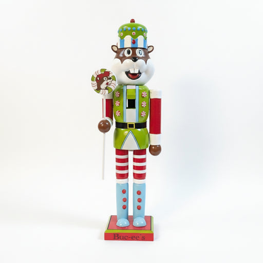 Buc-ee's Holiday Nutcracker - 2025 is holding a Lollipop and its a light green and blue with candies. 