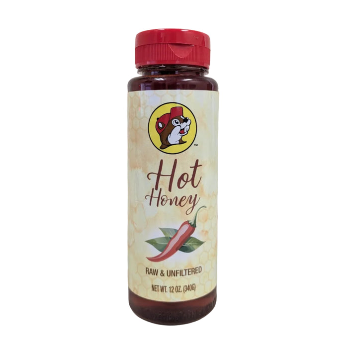 A 12 oz. plastic squeeze bottle of Buc-ee's Hot Honey standing upright against a white background. The label features the circular Buc-ee's beaver mascot logo, cursive text reading "Hot Honey", an illustration of a red chili pepper with green leaves, and the text "RAW & UNFILTERED" and "NET WT. 12 OZ. (340g)". The bottle is topped with a textured red plastic cap.