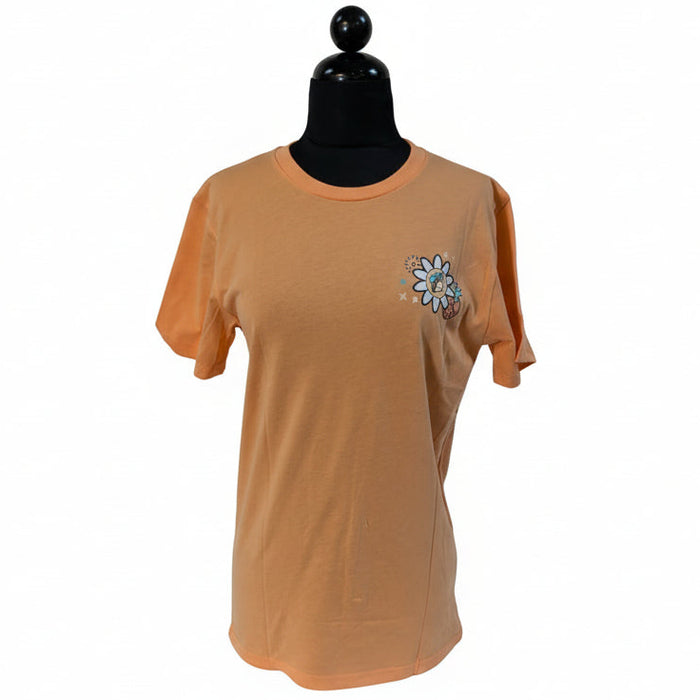 Front view of a coral Buc-ee's t-shirt on a mannequin, featuring a large retro daisy graphic with the beaver mascot wearing a backwards cap in the center. The design is surrounded by pastel wildflowers and peace signs, with blue curved text underneath reading "I Deserve A Little Treat."