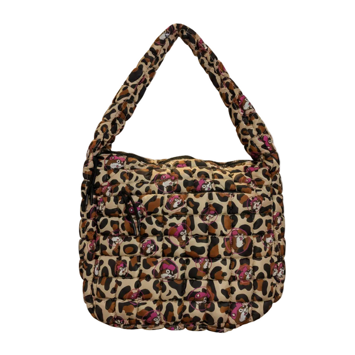A professional product shot of the Buc-ee’s Leopard Pink Puffy Tote Bag isolated against a solid white background. The bag is made of a tan and black leopard print quilted fabric, featuring a repeating pattern of the Buc-ee's beaver mascot wearing a pink hat inside pink circles. The bag is shown with its thick, matching quilted shoulder strap arched upward. The front of the bag features a horizontal zippered pocket with black pull strings, maintaining a sleek and functional design.