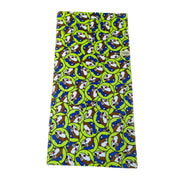 A high-visibility lime green beach towel covered in a repeating pattern of the Buc-ee's beaver mascot wearing a blue hat and a cheerful expression. Displayed on a clean white background.