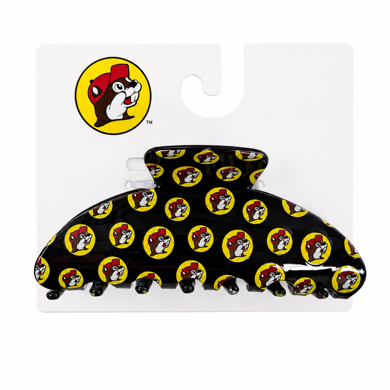 A glossy black curved acrylic hair claw clip mounted on a white Buc-ee's display card, featuring a repeating pattern of the red and yellow Buc-ee's beaver logo.
