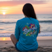 Buc-ee's Long Sleeve Performance Tropical Turquoise Shirt on a woman looking at the sunset.