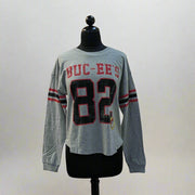 Buc-ee's Long Sleeve Raglan Crop Shirt. Gray long sleeve crop with the number 82 large on the front with the word Buc-ee's. 