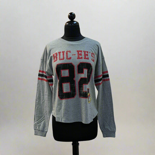 Buc-ee's Long Sleeve Raglan Crop Shirt. Gray long sleeve crop with the number 82 large on the front with the word Buc-ee's. 