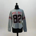 Buc-ee's Long Sleeve Raglan Crop Shirt. Gray long sleeve crop with the number 82 large on the front with the word Buc-ee's. 