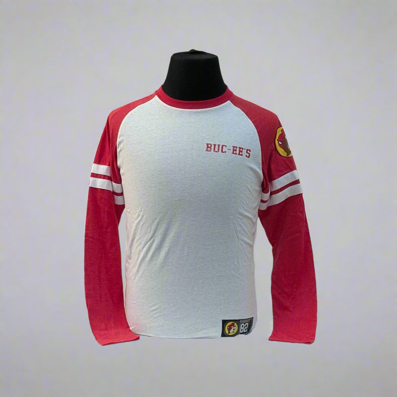 Buc-ee's Long Sleeve Raglan Shirt. Sleeves are red the body is white and it has the logo on the top left sleeve. 