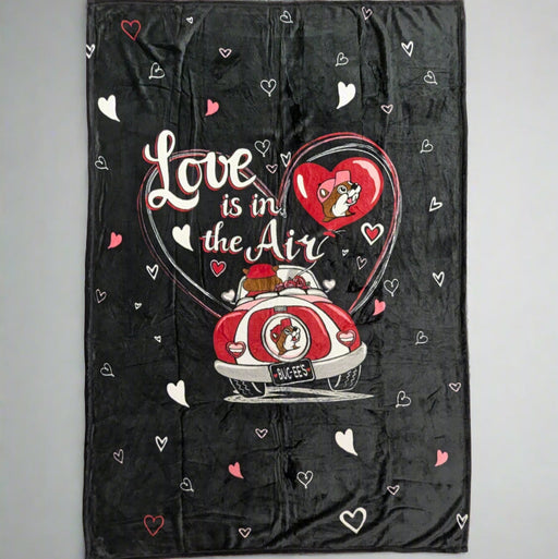 A black fleece blanket featuring Buc-ee’s Valentine’s “Love is in the Air” design with a red car, heart accents, and festive details. Soft, warm, and perfect for Valentine’s Day celebrations or everyday comfort.




