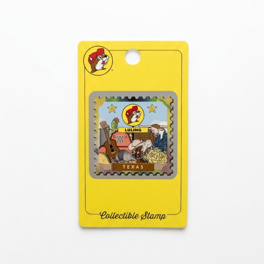 A postage-stamp-style souvenir with perforated metallic silver edges on a yellow packaging card. The stamp artwork includes a Buc-ee's Luling sign, Texas Longhorn, armadillo, acoustic guitar, red barn, bluebonnets, and cowboy boot, with "TEXAS" printed at the bottom.