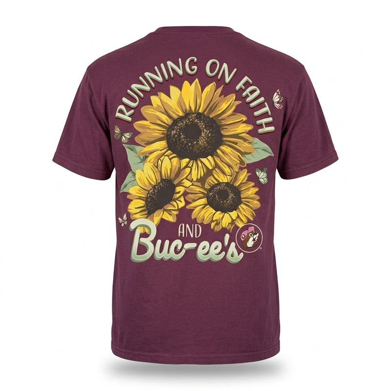 Back view of a maroon Buc-ee's T-shirt featuring bright yellow sunflowers, butterflies, the Buc-ee's logo, and text reading "Running on Faith and Buc-ee's."