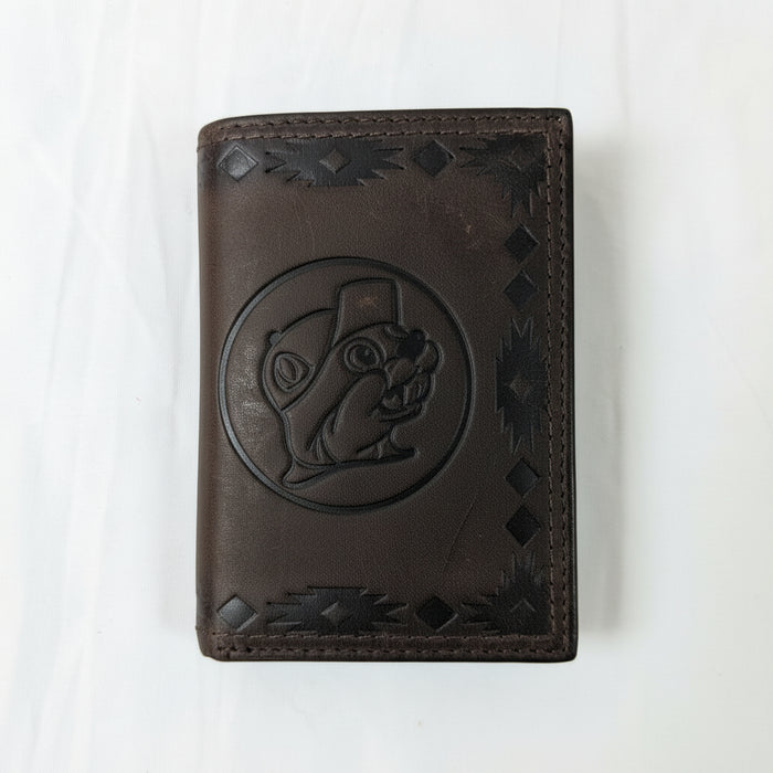 Buc-ee’s Men’s Genuine Leather Aztec Wallet in trifold style, featuring dark brown leather with Aztec-tooled edges and stamped Buc-ee’s logo, displayed on a clean white background.