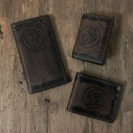 Three Buc-ee’s Men’s Genuine Leather Aztec Wallets in checkbook, bifold, and trifold styles, featuring dark brown leather with Aztec-tooled edges and stamped Buc-ee’s logo, displayed on a clean white background.