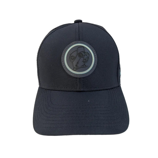 A front-facing view of a structured navy blue performance cap resting on a white background. The center features a circular, dark tonal rubber patch showcasing the Buc-ee's beaver mascot, outlined by a thin mint green ring.