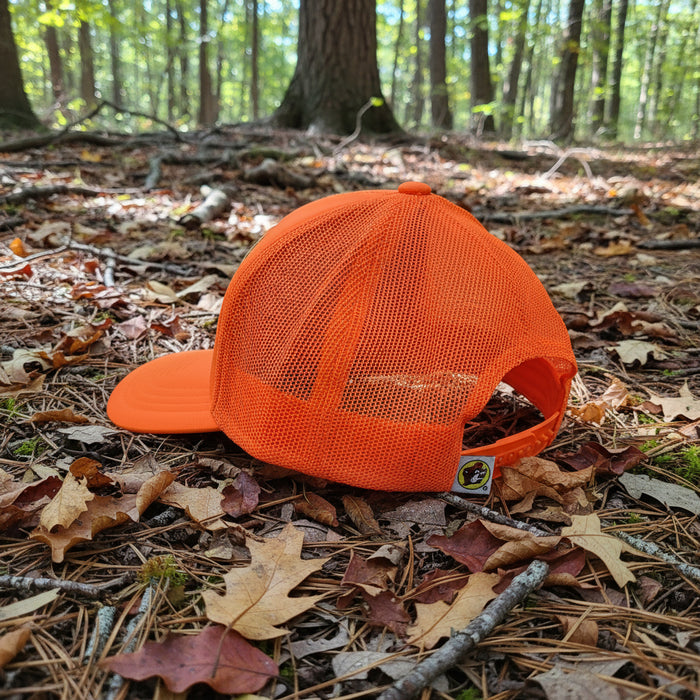 Stand out and stay safe in the great outdoors with the Buc-ee’s Orange Hunter Hat. This high-visibility trucker cap features a bright fluorescent orange color that’s perfect for hunting, hiking, or any adventure where you want to be seen. The front panel sports a bold Buc-ee’s oval logo in black with stars for a classic, rugged look, while the mesh back keeps things cool and breathable. With an adjustable snapback closure, this hat fits most head sizes comfortably.