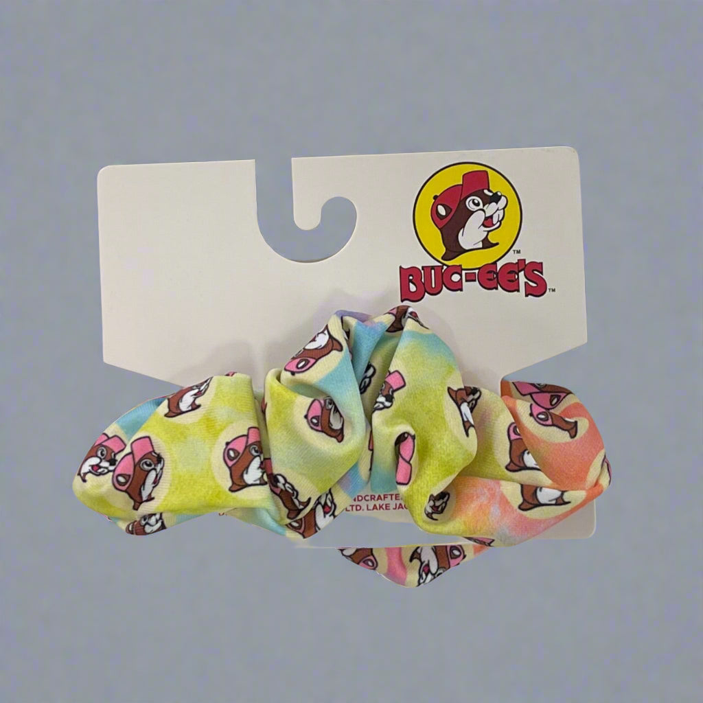 Buc-ee's Pastel Tie Dye Scrunchie with orange, yellow, blue, and pink Buc-ee's logos all over. 