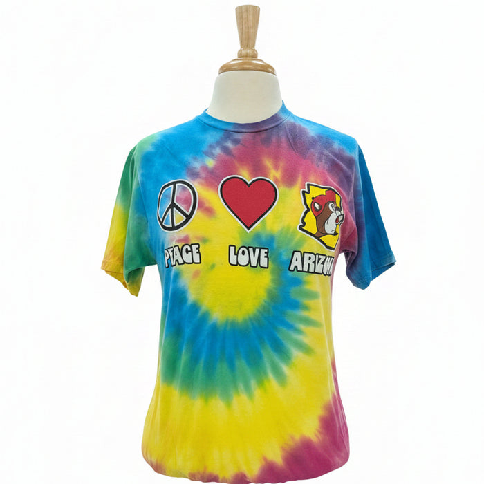 Tie-dye t-shirt with peace, love, and art designs on a mannequin in a store setting.