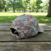 Side and back view of a pink camouflage Buc-ee’s baseball cap showing the adjustable strap and multicolor camo pattern.