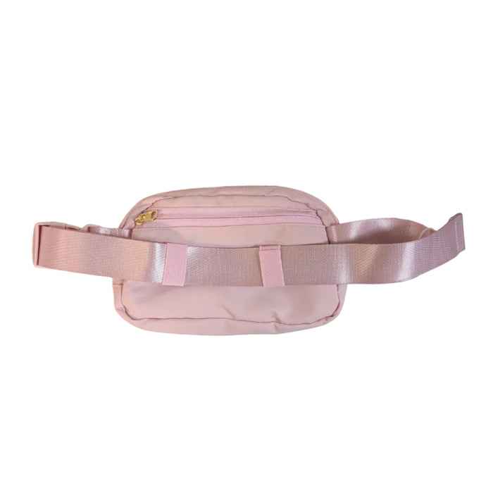 A top-down product photograph of the back of the pink Buc-ee's belt bag. This side features an exterior zippered pocket with a gold-tone zipper pull, and the adjustable woven strap is neatly threaded through two fabric loops on the back panels.