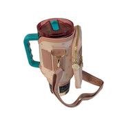 Buc-ee's pink crossbody tumbler bag wrapped around a 40oz tumbler with handle to demonstrate fit and usage.