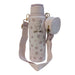 Front view of a pastel pink 40 oz Buc-ee's water bottle with an all-over pink rose pattern, displayed on a clean white background. It features a metallic gold Buc-ee's logo on the front and is attached to a wide pink crossbody shoulder strap with a small, matching zippered coin pouch.