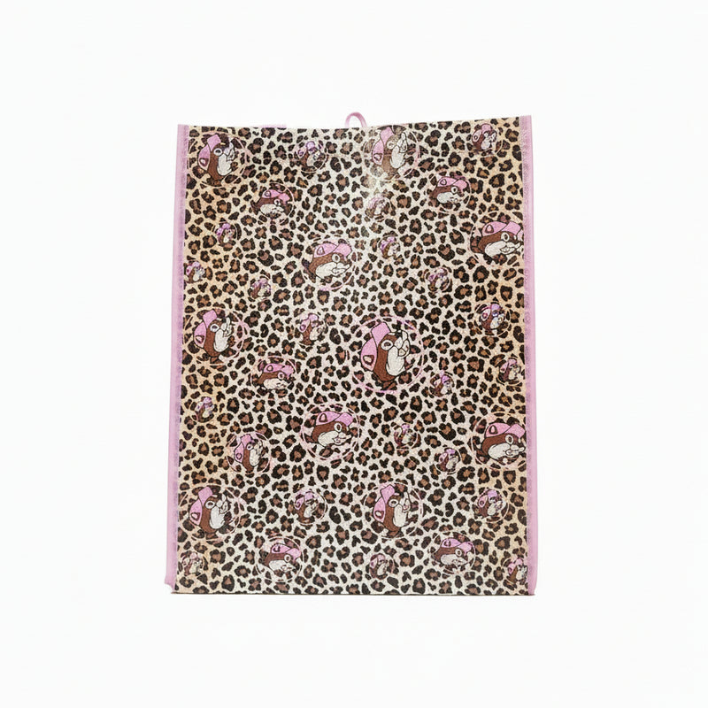 Back side of a Buc-ee’s Pink Leopard Tote Bag featuring an all-over pink and brown leopard print pattern with repeating images of Buc-ee’s beaver mascot wearing a pink hat, bordered with pink trim, displayed on a clean white background.