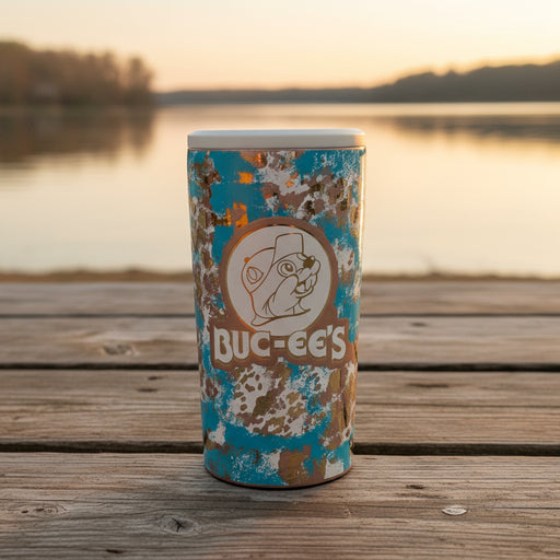 Buc-ee’s Ranch Leopard 4-in-1 Drink Cooler with tan, blue, and white camo-style leopard pattern and Buc-ee’s logo on the front, designed to fit most 12oz cans, skinny cans, and bottles.