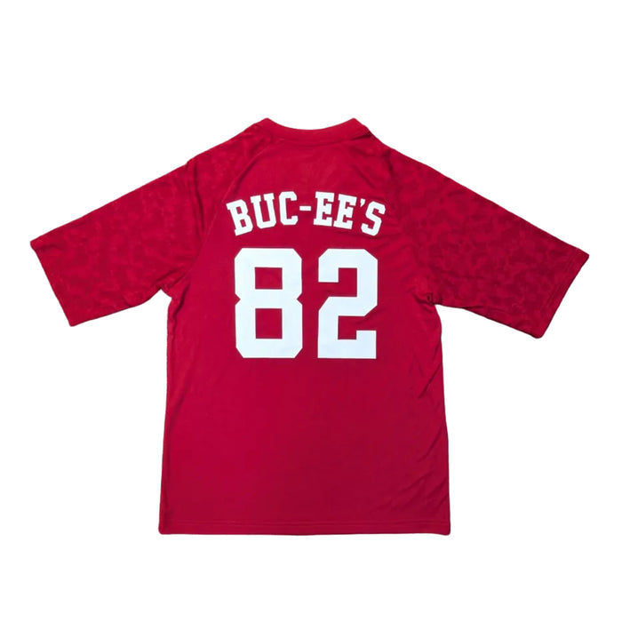 Back view of a Buc-ee’s Red Camo Soccer Jersey showing the word 'BUC-EE’S' and the number '82' screen-printed in large white block letters, with the tonal red camo pattern visible on the sleeves. Displayed on a clean white background.