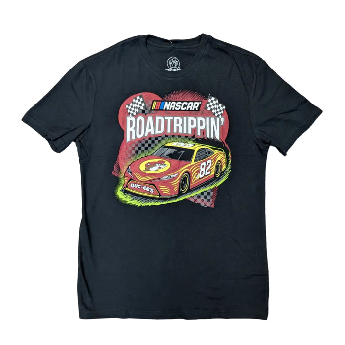 A flat-lay product photograph of a black short-sleeve t-shirt. The center features a vibrant graphic of a red and yellow NASCAR stock car with the number 82 and a Buc-ee’s logo on the hood. The words 'NASCAR' and 'ROAD TRIPPIN’' are displayed above the car against a backdrop of checkered flags and red speed lines. Displayed on a clean white background.