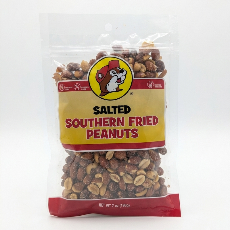 A 7 oz clear bag of Buc-ee's Salted Southern Fried Peanuts, showcasing the crispy fried peanuts through the packaging with the classic yellow Buc-ee's mascot logo centered on the label.
