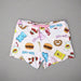 Close-up of Buc-ee’s pajama shorts showing playful snack icons like pretzels, jerky, and gummy bears on a pink background.