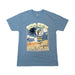 A blue slate short-sleeve crew neck t-shirt laid flat on a white background. The shirt features a large, rectangular vintage-style graphic on the chest. The design shows a beach scene with a prominent palm tree on the left, ocean waves, and a wooden signpost pointing to "Beaver Nuggets" and "Clean Restrooms." A circular logo of the Buc-ee's beaver mascot wearing a green cap is positioned near the top, bordered by the text "Buc-ee's" above and "South Carolina" along the bottom in a stylized font.