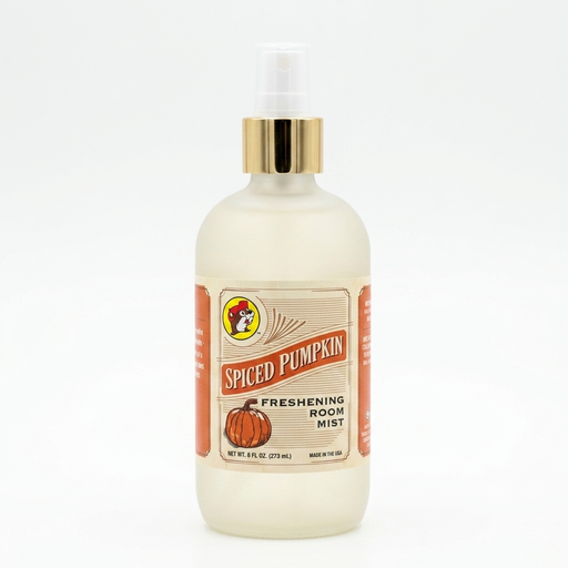 A square, close-up photograph of a frosted glass bottle with a clear spray nozzle and a gold cap, containing a light yellow-colored liquid room mist. A vintage-style paper label wrap around the front features a cartoon drawing of a beaver in a hat and the words "SPICED PUMPKIN," "FRESHENING ROOM MIST," "NET WT. 8 FL OZ (273 ML)," and "MADE IN THE USA," along with a stylized drawing of a pumpkin. The background is solid white.