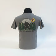 The Buc-ee’s “Spotted at Buc-ee’s” Shirt captures the legendary moment Bigfoot was seen grabbing snacks under the Texas stars. Featuring a classic gray tee with a bold Buc-ee’s logo on the front and a mysterious Bigfoot silhouette against a moonlit forest on the back, this shirt is perfect for fans of roadside adventures and tall tales alike.