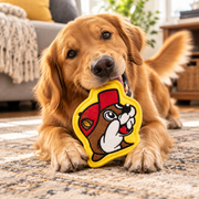 Golden retriever dog on a rug chewing the Buc-ee the Beaver squeak toy