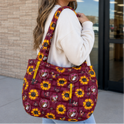 Buc-ee’s Sunflower Tote Bag on a lady heading into a store. 