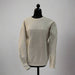 Front view of a cream-colored Buc-ee’s sweater with embroidered Buc-ee’s script across the chest, displayed on a mannequin.