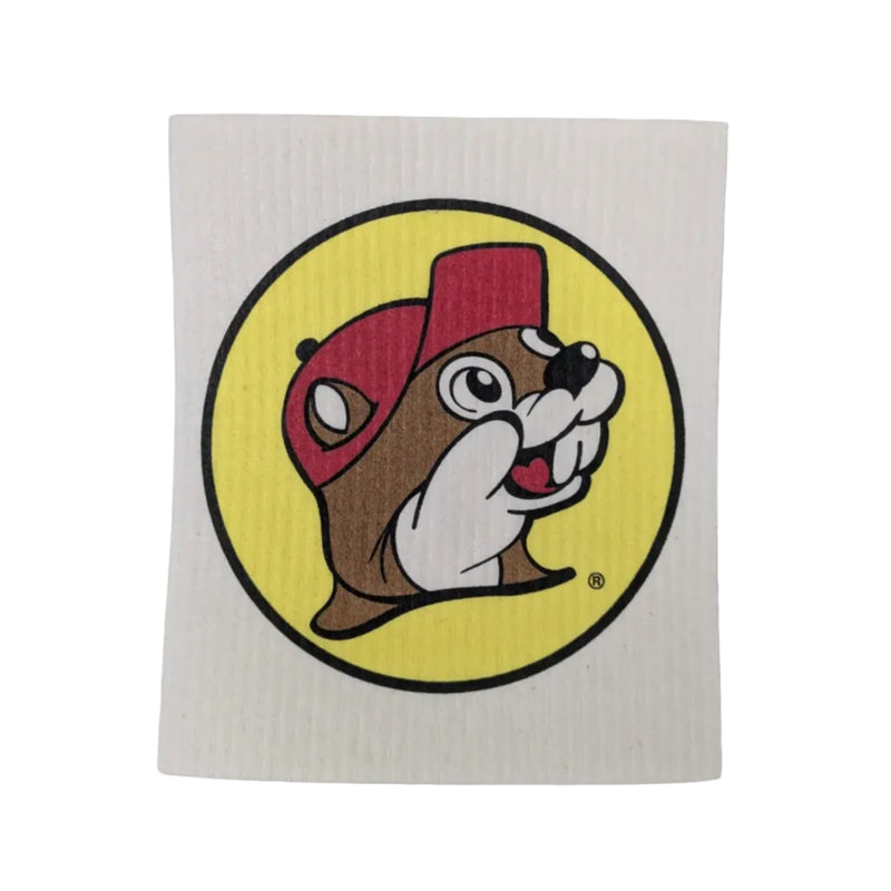 A square, textured white Buc-ee's Swedish dishcloth featuring a large, centered print of the iconic round yellow logo with the smiling beaver cartoon mascot wearing a red cap, displayed on a white background.