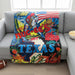 Buc-ee’s Texas plush blanket with colorful collage design, American flag, Buc-ee the Beaver graphic, and large “TEXAS” lettering laid on the front of a couch with a football on the floor and a bowl of popcorn next to it.
