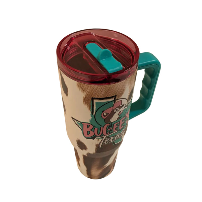 A top-down view of the translucent pink plastic lid on the tumbler. The lid features a central teal accents piece and a teal flip-up straw mechanism, which is currently folded flat and integrated into the top surface of the lid.